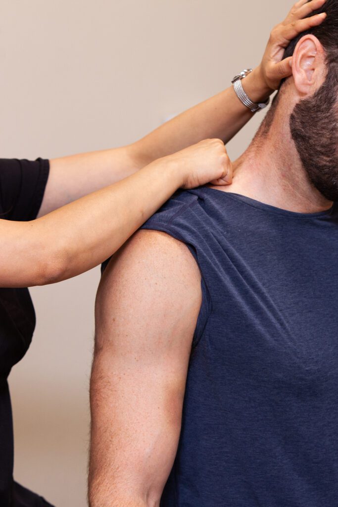 Physical therapist performing shoulder joint mobilization and manual therapy on a patient at Reform Physical Therapy clinic in Thousand Oaks
